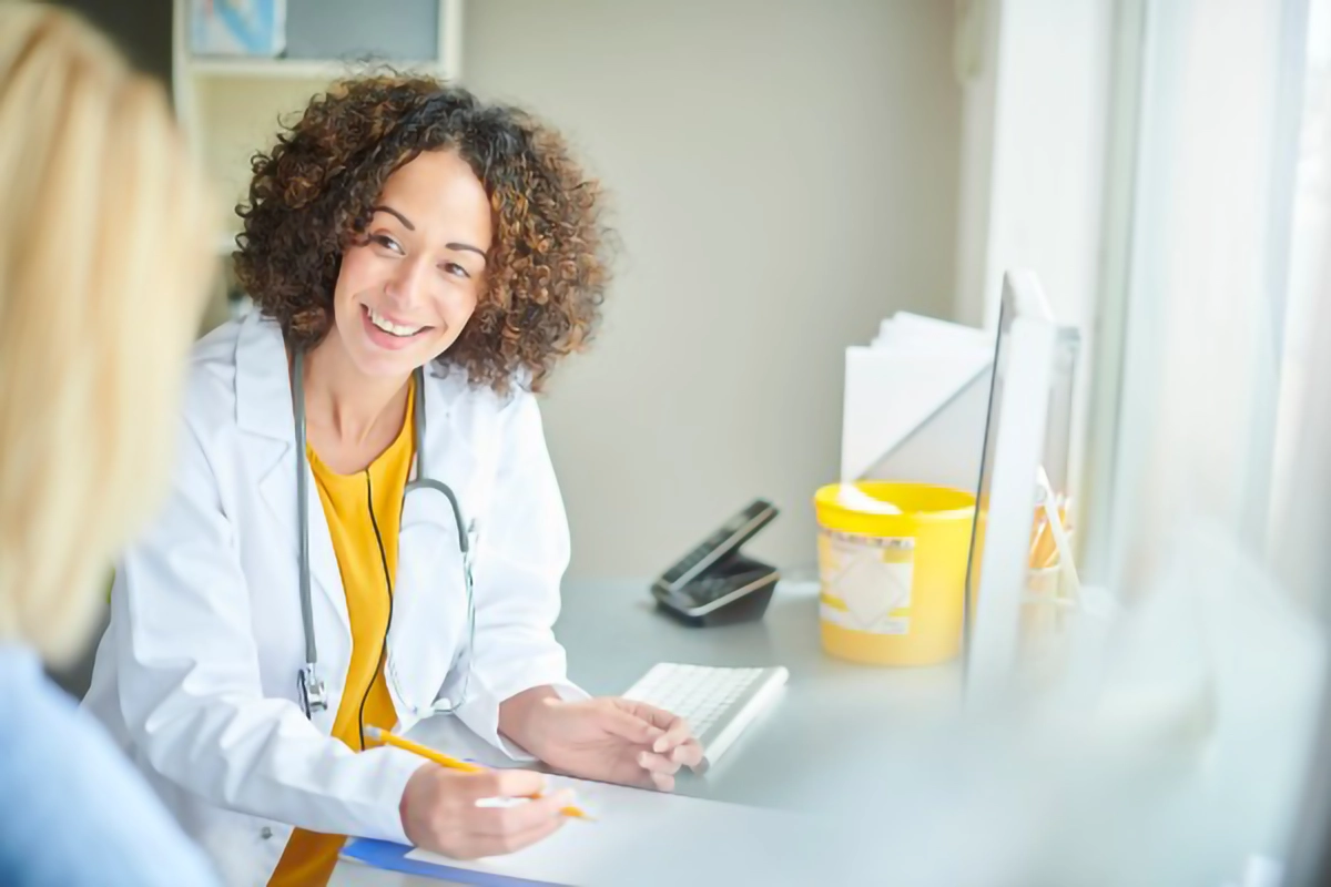 Image shows a GP in a appointment with a patient